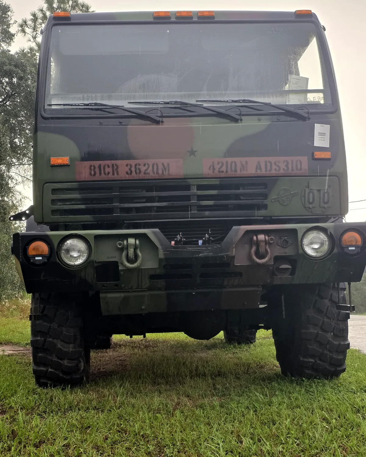 iFIXED LMTV M1078A1 cargo truck in woodland camouflage, seen from the front