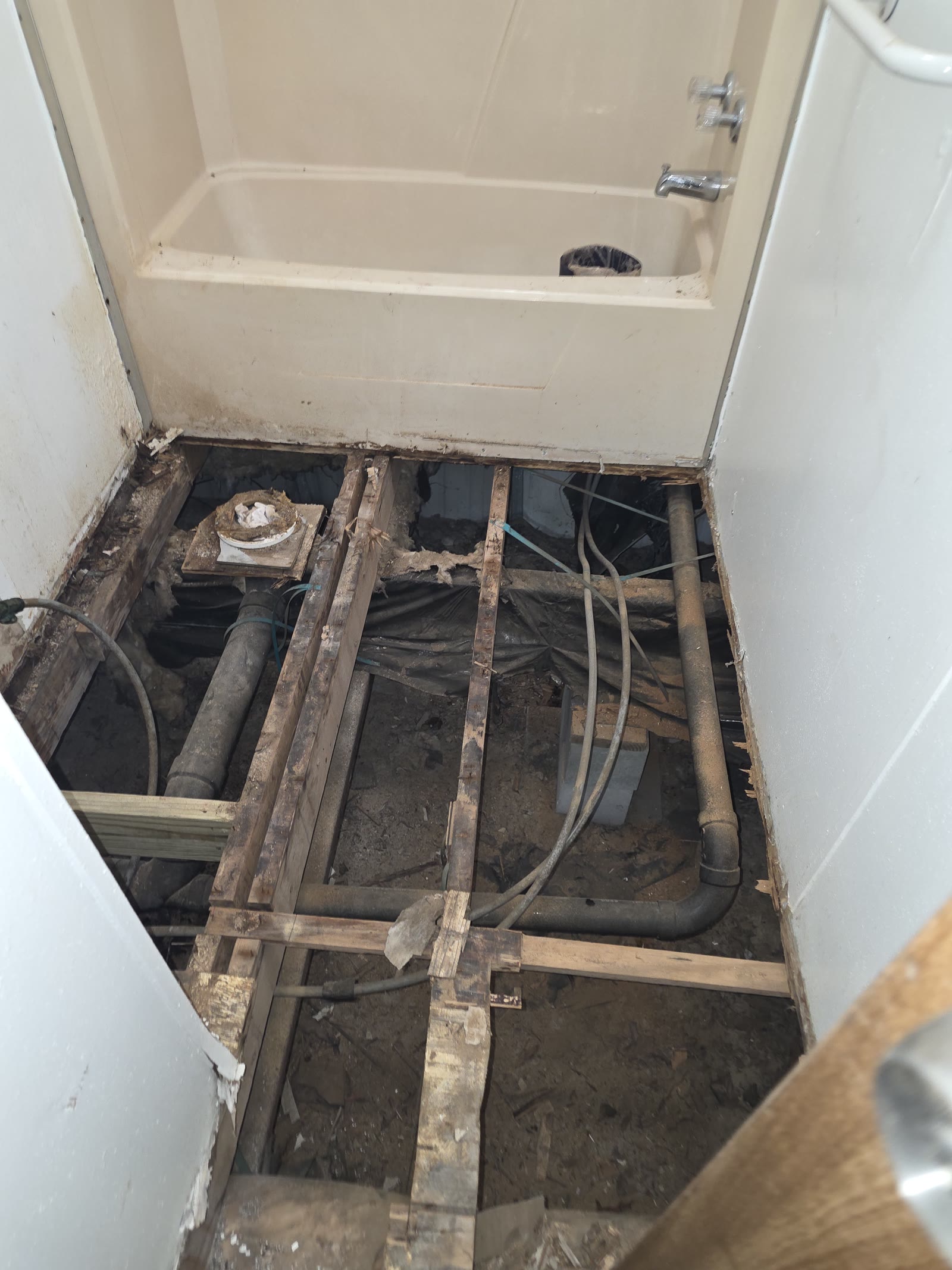 Bathroom renovation preparation work with demo and framing visible